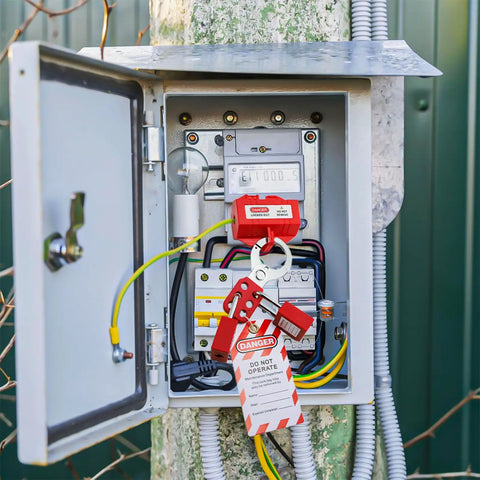 Electrical panel with installed 90 Piece Lockout Tagout Kit With Red Tool Box For Electrical Safety, lockout tags and padlocks.