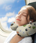 Woman using Women's Travel Neck Pillow Memory Foam U Shaped with cute sushi pattern on an airplane.
