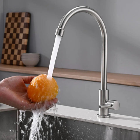 A Total Game Changer For Your Modern Kitchen Or Home Bar With This Dependable Cold Water Only Faucet Finished In Smooth Brushed Nickel And Built Darn Tough From Pure Food Grade 304 Stainless Steel pouring water over an orange.