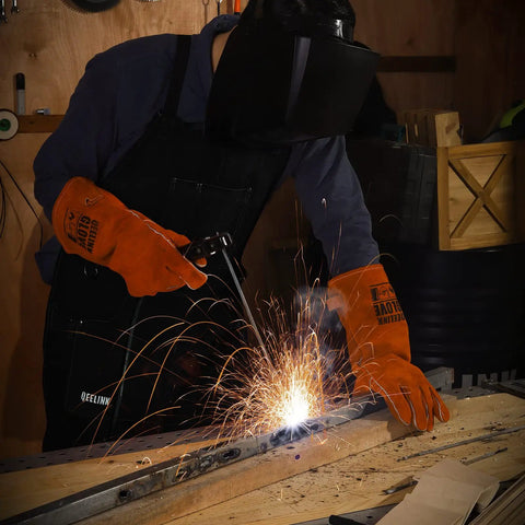 Person welding in workshop wearing Heavy Duty Leather Welding Apron With Six Pockets For Pro Welders, heat resistant, flame retardant, black