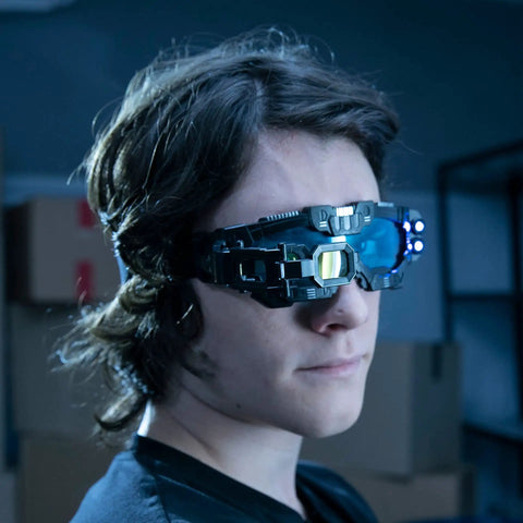 Kid wearing Micro Gear Set And Night Mission Goggles With Adjustable Belt And LED Light Beams Glasses in a dark room