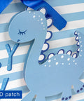 Blue Dinosaur Baby Boy Gift Bag With Tissue Paper And Greeting Card Durable Ribbon Handles And Reinforced Bottom 13 By 10 By 5 Inches Perfect For Baby Showers New Parents And More featuring a 3D baby dinosaur design on striped background.