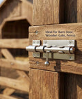 Heavy Duty Six Point Three Inch Stainless Steel Sliding Gate Bolt Lock With Padlock Ready Opening And No Sweat Mounting Kit For Barn Doors Backyard Fences And Garden Gates mounted on wooden gate.