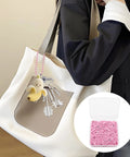 Person with white bag using 100 Pcs Metal Ball Bead Chains 4.72 Inch Adjustable Keychain Beaded Chains With Connectors For DIY Crafts Pink Durable Rustproof Ideal For Beadwork Projects, Key Chains, Jewelry Making And DIY Decor. Inset shows box of pink chains.