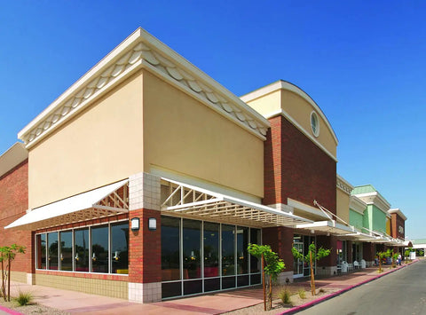 Commercial building exterior with decorative awnings and large windows