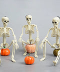 Three 16 Inch Posable Halloween Skeletons With Movable Joints Full Body Prop For Haunted Houses Indoor Decor Spooky Party Props, sitting.