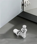 Upgrade Your Ride With A Rock Solid 16 Piece Wheel Lug Nut Kit Featuring Tight Grip Hub Screw Caps That Keep Tires Secure For Tough Drives And Smooth Rides While Protecting Valuable Hardware., silver metal wheel lug nut kit on gray floor beside cabinet hinge