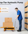 Side view of orange hydraulic scissor lift table cart with four wheels, carrying two cardboard boxes.