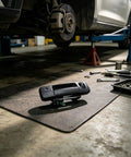 RDHFTNIHU Access Latch Component resting on a workshop mat, surrounded by tools under a lifted pickup truck.