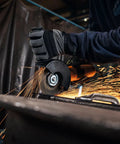Top Shelf 1400 Watt Angle Grinder Packs Knock Tough 125mm Cutting Muscle, Tilting Gear Head, And Lock Off Shield in action cutting metal.