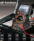 Magnetic 20000 Count TRMS Digital Multimeter With Auto Ranging on car battery, showing display and test leads