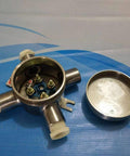 Front view of stainless steel explosion-proof junction box, lid off, blue terminal plate and brass studs.
