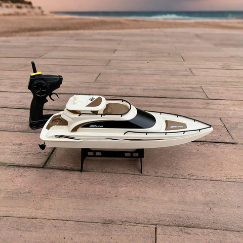 Remote Control Boat 4CH Electric RC Watercraft Yacht Style Sail Cruiser, perfect for lake and pool, shown on wooden deck.