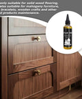 Premium 100ml Teak Oil For Wood Furniture And Hardwood Floor Restoration on wooden cabinetry with brass knobs.