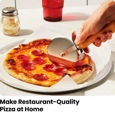 Person using a cutter on a pepperoni pizza made with Indoor Pizza Oven That Makes 12 Inch Pizzas Fast, Reaches Up To 800 Degrees Fahrenheit, Countertop Electric Maker With 5 Presets, Includes Pizza Stone And Peel For Easy Restaurant Quality Pies.
