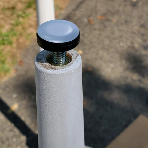 Close-up of Quarter Inch Threaded Leveling Feet With PTFE Bottom For Carpets And Hardwood Floors attached to furniture leg.