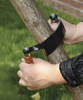 Pro Grade 10 Inch Curved Draw Knife Heavy Duty Woodworking Shaving Tool cutting bark from a log outdoors.