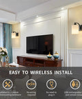 Sleek Matte Black Rechargeable Wall Sconces Set Of Two Wireless Dimmable Led Lights With Remote Easy Setup For Bedroom And Living Room All Day Battery Operated Lamps Heavy Duty Build Badass Style mounted beside a television.