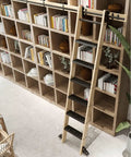 Heavy Duty Ten Foot Sliding Ladder Track Hardware Kit With Hanging Rail Rollers Stoppers Floor Wheels Track Supports And Connectors Built To Last For DIY Home And Garage Projects Ladder Not Included shown in library setup.