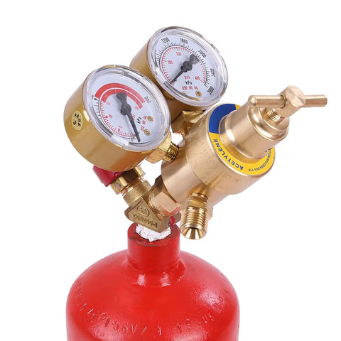 Close-up of dual gauge on Brass Torch Welding And Cutting Kit with red tank and brass fittings.