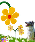 Crazy Daisy Sprinkler Dancing Sunflower Water Sprinkler for Lawn Garden Yard Watering And Outdoor Dog Play next to a dog in grass.