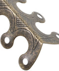 Close-up of Heavy Duty Antique Metal Corner Guards 20 Pack For Cabinets And Albums with decorative design and predrilled holes.