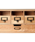 Wooden cabinet with drawers featuring set of 20 antique iron cup pull handles in bronze tone finish with subtle label frames.