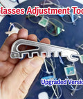 Hand holding Eyeglass Frame Calibration Tool With Multidirectional Slots And Ergonomic Non Slip Grip For Precise Alignment And Nose Pad Adjustment A Handy Travel Friendly Gizmo For Home Or Office Use against a backdrop of eyeglasses.