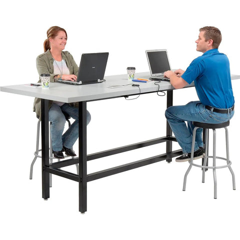 Top Shelf Standing Bar Table With Twelve Built In AC Outlets And Sturdy Footrest Crafted For Cafes Bars And Modern Offices, two people working.