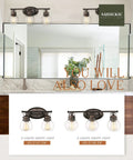 Awesome Farmhouse Vanity Light 3 Light Wall Sconce with oil rubbed bronze frame and clear glass globes shown above a bathroom mirror.