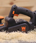 Cordless Planer With Brushless Motor, Dual 3-1/4-Inch Blades on wood shavings, ergonomic handle, 20V Max battery pack