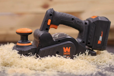 Cordless Planer With Brushless Motor, Dual 3-1/4-Inch Blades on wood shavings, ergonomic handle, 20V Max battery pack