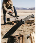 Camp 10 Machete 10 Inch Recurve Fixed Blade resting on wood, full tang, tan handle, ideal for outdoor and yard work