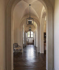Vintage Foyer Lantern Pendant Light With 4 Light Iron Matte Black Chandelier Hard Wired Fixture hanging in elegant arched hallway