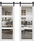 Top Shelf Double Barn Doors Featuring Crisp Clear Glass Panels And Rock Solid Black Steel Track Hardware Promise A Slick Slide Performance For Everyday Household Spaces, showcasing two white pine doors with glass panels.