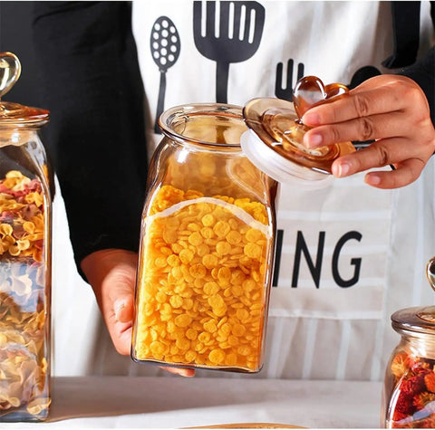 Top Shelf Durable Borosilicate Glass Jar Slick Amber Tint Secure Flip Lid Seal Keep Your Coffee Beans Spices And Dried Fruit Fresh In Style No Sweat Kitchen Pantry Organization Solution That Goes Hard with yellow cereal inside.