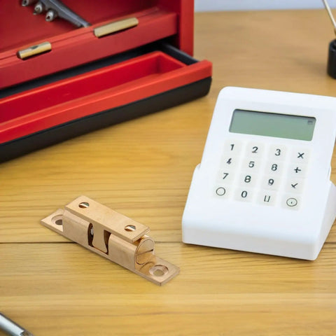 Copper Ball Catch Door Latch Set For Boats And Yachts on wooden surface beside tools