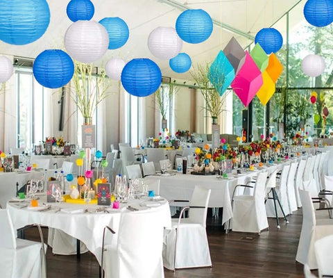 Blue Paper Lanterns Set Of 12 Assorted Sizes 6 Inch 8 Inch 10 Inch And 12 Inch Chinese Round Hanging Lamps in event venue with tables.
