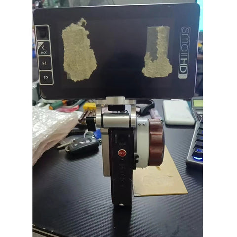 HangTon monitor mounting bracket on Tilta Nucleus-M hand unit for SmallHD monitor; 1/4 3/8 M4 screws.