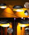 Solar Fence Lights Six Pack With 9 LED Warm White Outdoor Waterproof UFO Design mounted on wooden fence and gate at night