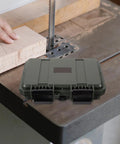 Dang Tough Portable Waterproof Plastic Toolbox With Rugged Latches For Nails Screws And Small Parts on a workbench.