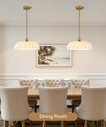 puncoll 15.7 Vintage Milk Glass Pendant Light Kitchen Island above a dining table in a modern dining room setting.