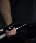 Sick Grip Black Cotton Lifting Wrist Straps Featuring Hella Padded Neoprene Cuffs for Heavy Deadlifts during powerlifting.