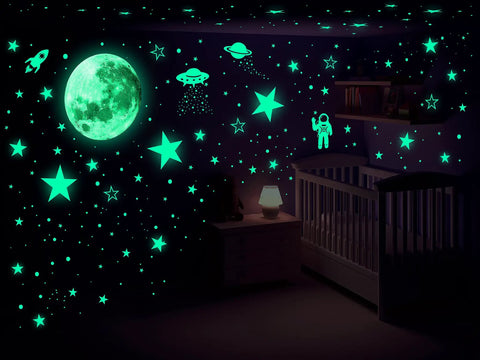 Glow In The Dark Stars And Planets Ceiling Wall Decor Kit With Rockets And Astronauts For A Galaxy Themed Kids Room Or Nursery Bedroom Totally Kid Friendly 1078 Piece Starry Sky Sticker Set - glowing moon, stars, and astronaut decals on nursery wall.