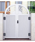 Two white metal gate hinges mounted on a decorative arch gate, front view