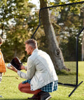 Parent and child using Z Screen Pitching Net 5x7 Ft Portable Baseball Backstop For Backyard And Field Training, nylon net setup outdoors