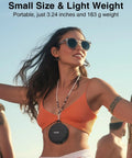 Woman wearing a compact portable speaker around neck, small size, lightweight, suitable for travel or outdoor use.