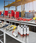 Front view of steel 3/8 air hose fittings on a metal workbench; silver adapters with red ends and hoses in background