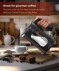 Glass Electric Tea Kettle With Tea Infuser And Precise Temperature Knob 1200W Fast Heating BPA Free pouring into a cup