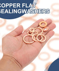 Hand holding M14 flat copper washers from the 60Pcs M14 Flat Copper Washers Hardcore Metric Sealing Crush Rings.